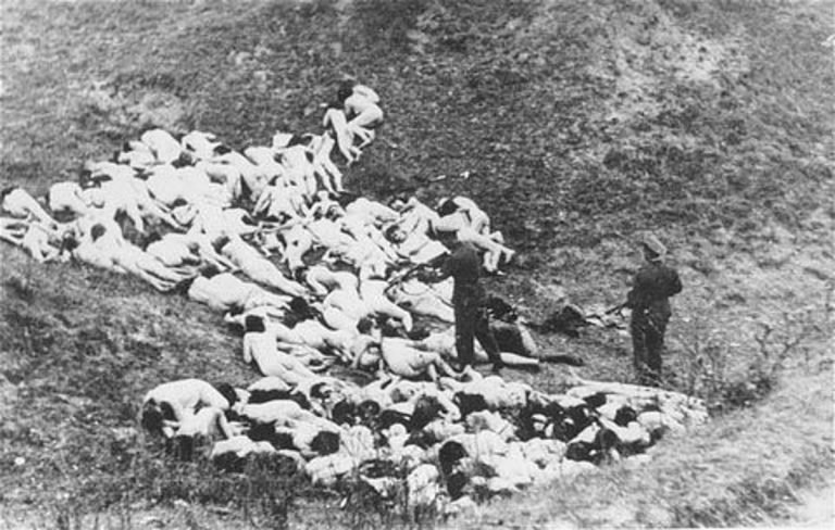 A-German-police-officer-shoots-Jewish-women-still-alive-after-a-mass-execution-of-Jews-from-the-Mizocz-ghetto-768x488.jpg