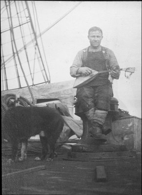 Portrait of Anton Omelchenko, expedition groom, playing musical instrument on board the Terra Nova ship..jpg